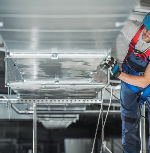 a technician installing ductwork