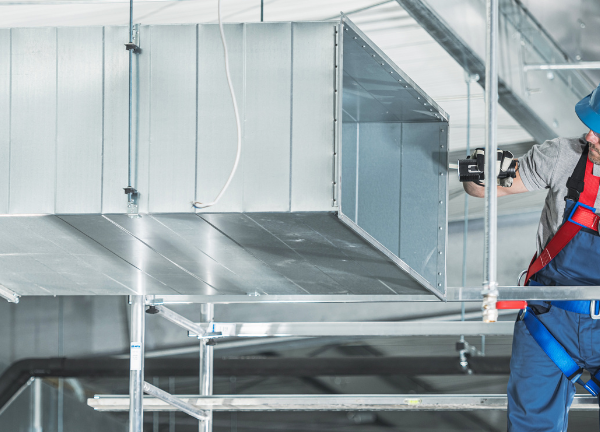 technician fitting ductwork by dynamic metalworks inc